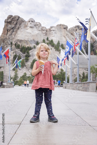 Little girl sightseeing at Mount Rushmoor National Memorial, eating an ice cream on vacation photo