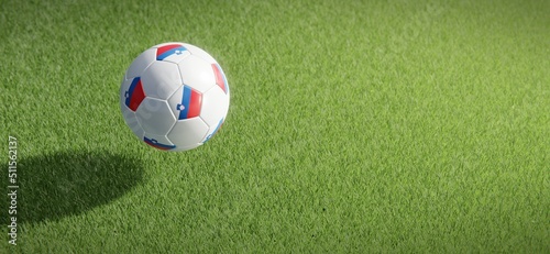 Football or soccer ball design with flag of Slovenia against grass pitch backdrop. 3D rendering