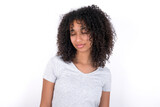 Young beautiful girl with afro hairstyle wearing gray t-shirt over white background nice-looking sweet charming cute attractive lovely winsome sweet peaceful closed eyes
