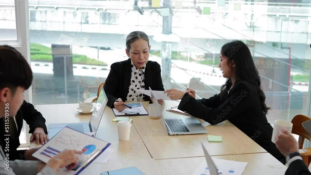 Professional business people discussing project plan and financial results in boardroom Professional business people discussing project plan and financial results in boardroom