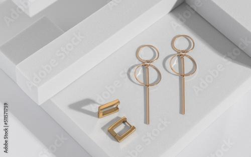 Modern geometric shape earrings on geometric white background