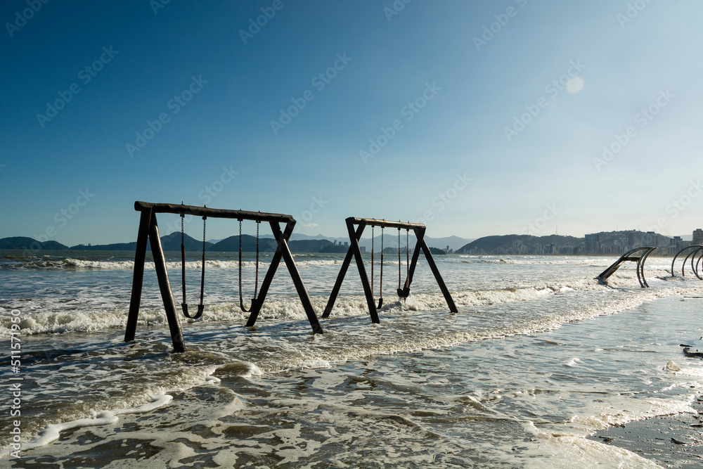 City of Santos, Brazil. High tide invades the sand strip and the children's playground. City of Santos, Brazil. High tide invades the sand strip and the children's playground.