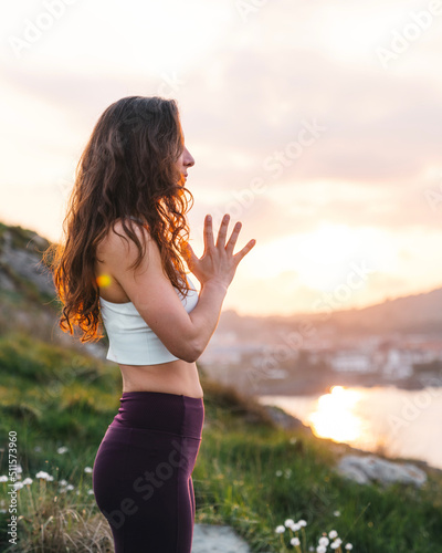 Slim woman doing yoga in nature photo