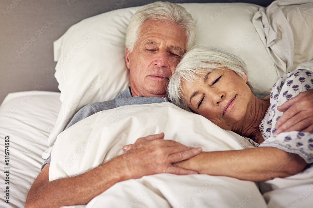 Moments like this are priceless. Shot of a senior couple sleeping in bed. Moments like this are priceless. Shot of a senior couple sleeping in bed.