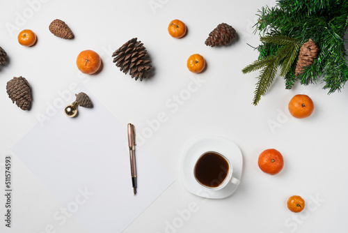 Christmas composition. Christmas frame with tangerines, fir and cup coffee on white table. Flat lay, top view © Golib Tolibov