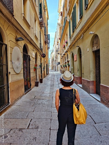woman from behind in the historic center of alghero sardinia