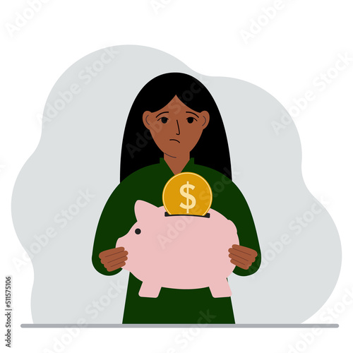 Sad woman holds a piggy bank, a coin falls into the piggy bank. The concept of saving finance, savings, investing finances.