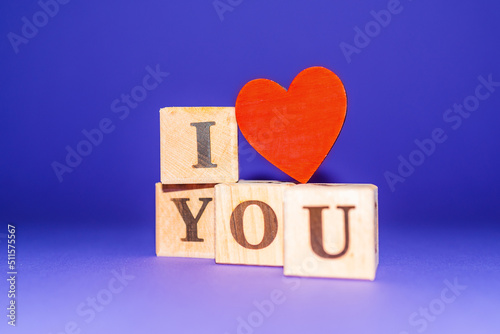 i love you text on wooden blocks heart. purple veri peri background.copy space.