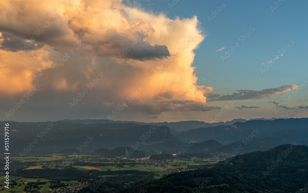Cumulus clouds at sunset with the view over the valley and mountains.
Cumulus clouds at sunset with the view over the valley and mountains.