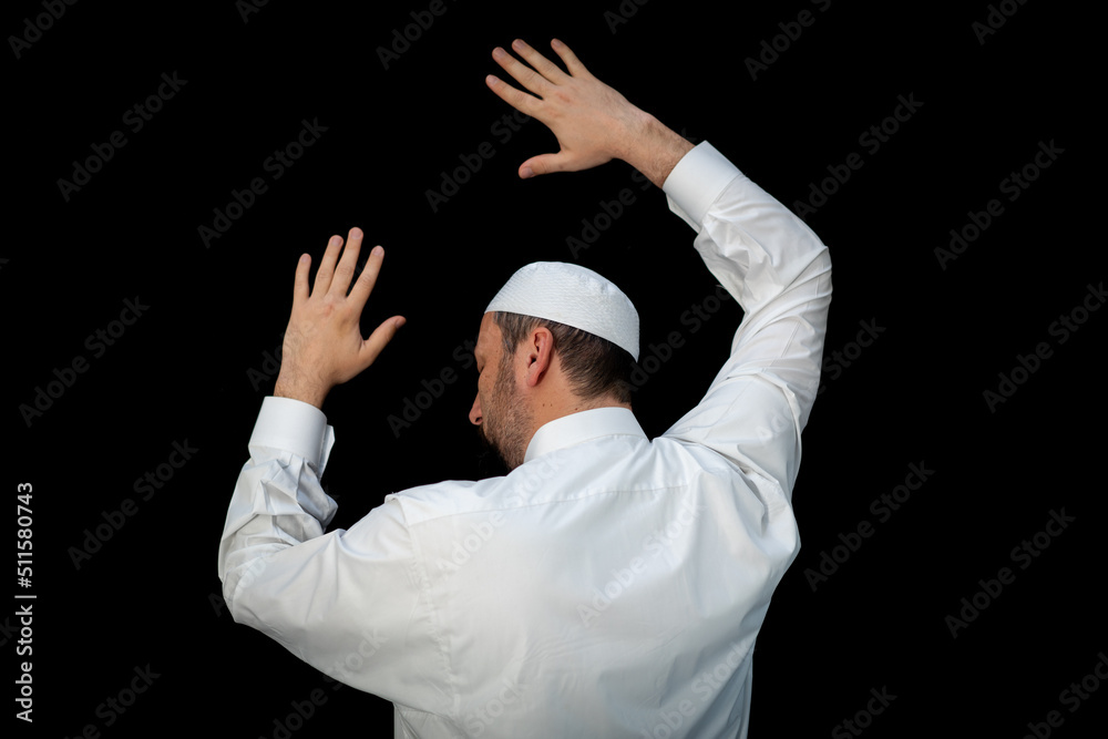 Muslim man standing and praying in the front of Kaaba in Mecca, KSA Muslim man standing and praying in the front of Kaaba in Mecca, KSA