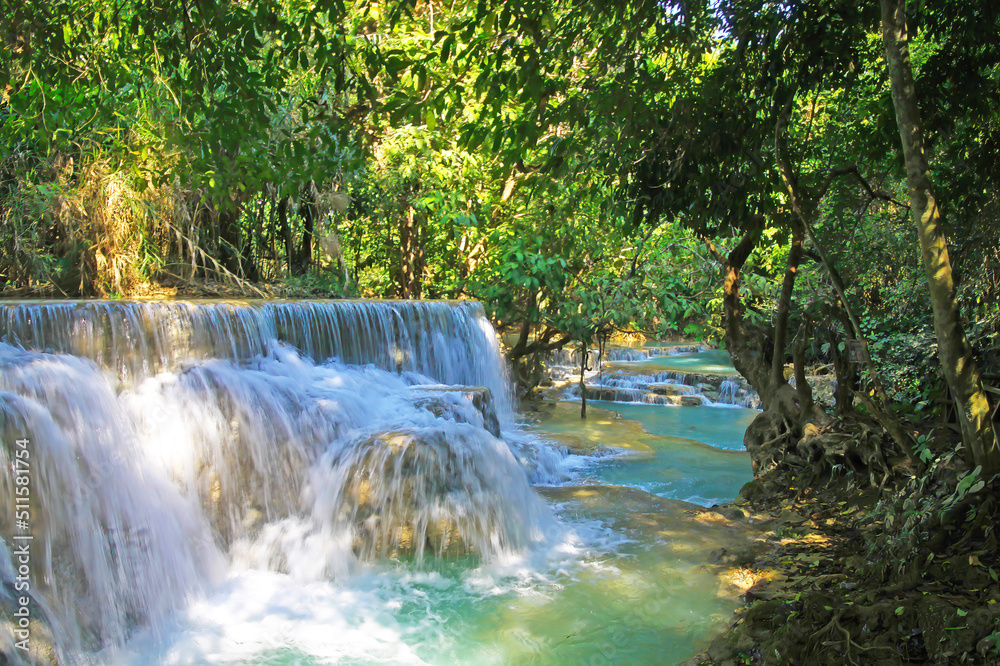 Beautiful secluded lonely tropical waterfall landscape, green jungle forest, rock cascade, blue turquoise river  - Kuang Si, Luang Prabang, Laos