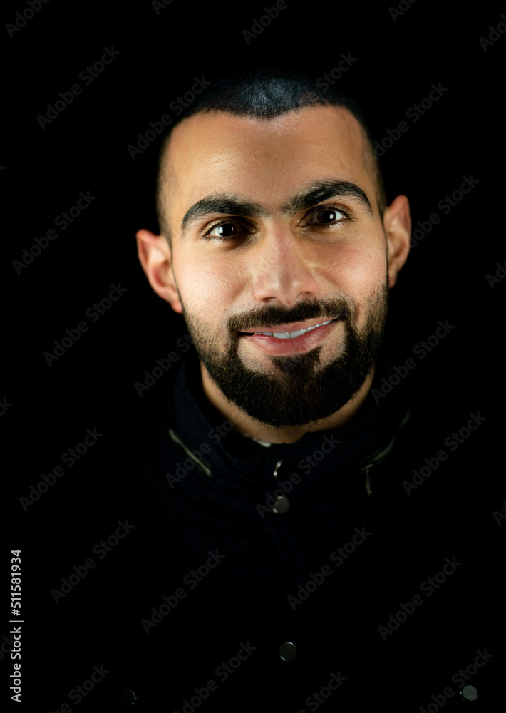 Fototapeta premium Portrait of young attractive man on a black background. High quality photo