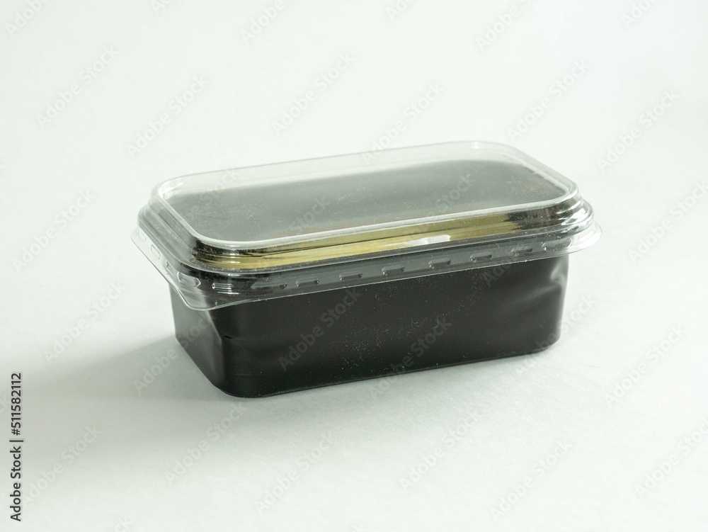 Black plastic container with transparent lid on white Black plastic container with transparent lid on white