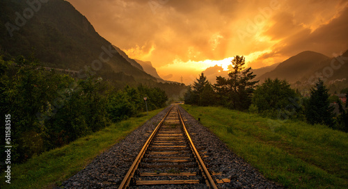 Evening and vivid sunset on the railroad tracks