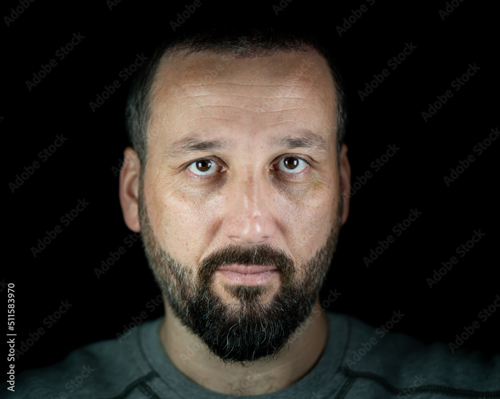 Portrait of 40 years old man on a black background. High quality photo Portrait of 40 years old man on a black background. High quality photo