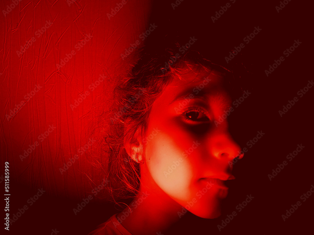 portrait of little girl in red light. portrait of little girl in red light.