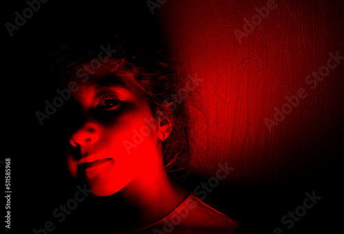portrait of little girl in red light.