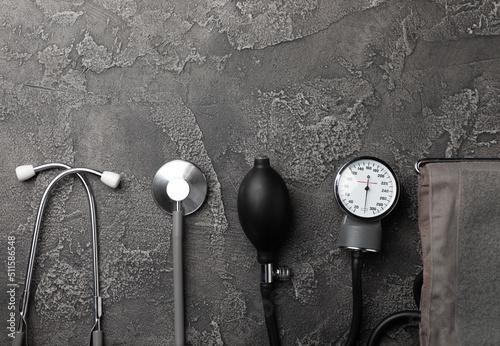 Black blood pressure monitor on a black marble background.Medical equipment blood pressure monitor.Health care. Place for text. Medicine concept. The concept of cardiology. photo