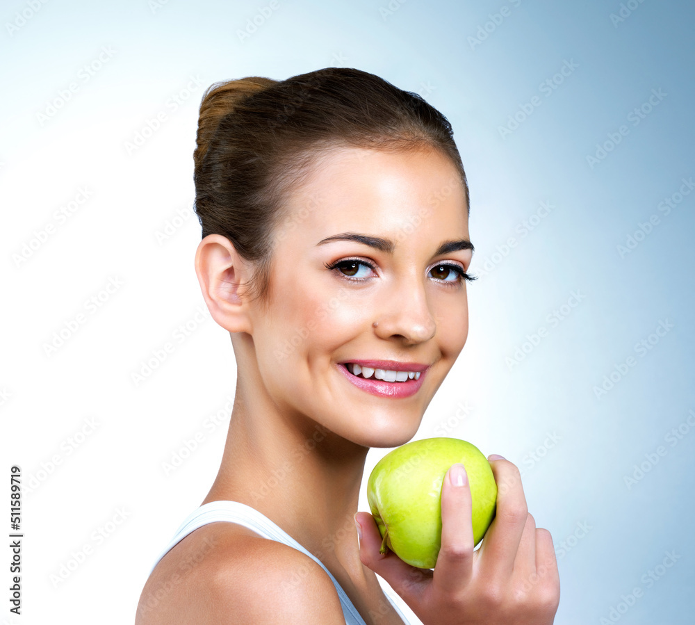 Its the secret to my healthy glow. Portrait of a health-conscious young woman posing with an apple in studio. Its the secret to my healthy glow. Portrait of a health-conscious young woman posing with an apple in studio.