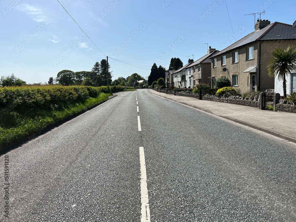 Looking down the, Skipton Road, with houses, hedgerow, and a blue sky in, Hellifield, Skipton, UK