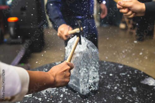 Obraz na płótnie Process of breaking the ice with hammer and ice pick, group of people smashing s