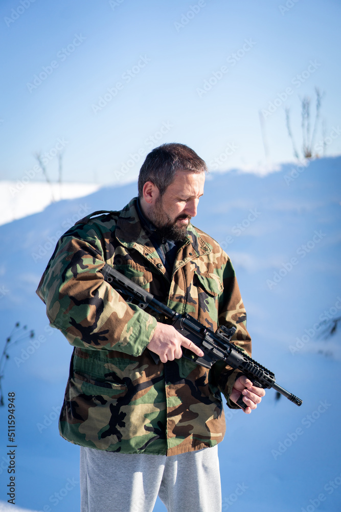 Fototapeta premium Male Soldier In Military Uniform On Winter Snow. High quality photo