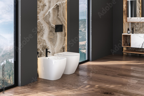 Toilet and bidet standing on parquet floor in beautiful modern bathroom with black and marble walls . Minimalist bathroom with modern furniture. 3d rendering
 photo
