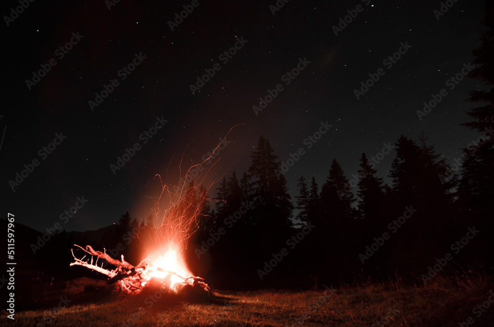 bonfire in the night with light trays flying, panoramic shot, full moon evening, burning wood, bonfire in the night with light trays flying, panoramic shot, full moon evening, burning wood,
