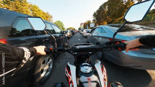 Man riding motorbike over streets. Driver rolling scooter from first view at streets. Motorcycles rolling. Concept. Outdoor. Daytime. Close-up of hands of male biker. Fast drone fpv flight. Road. City