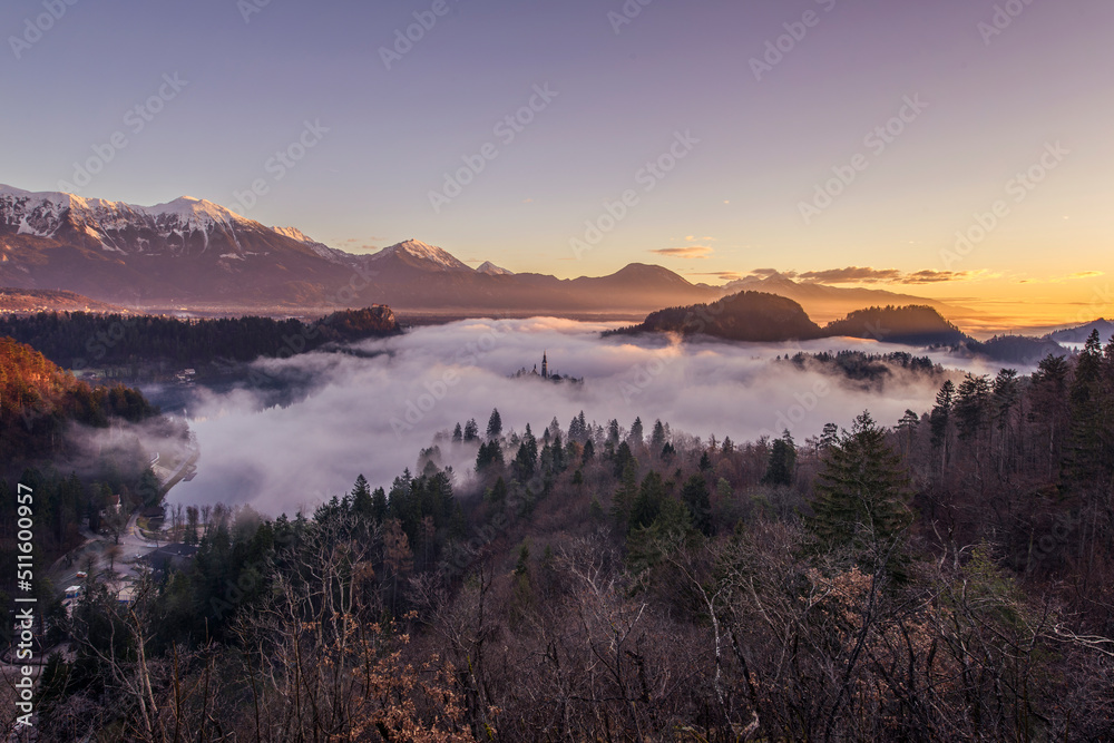 Lake Bled with the church and the castle on an autumn morning with fog and mist. 