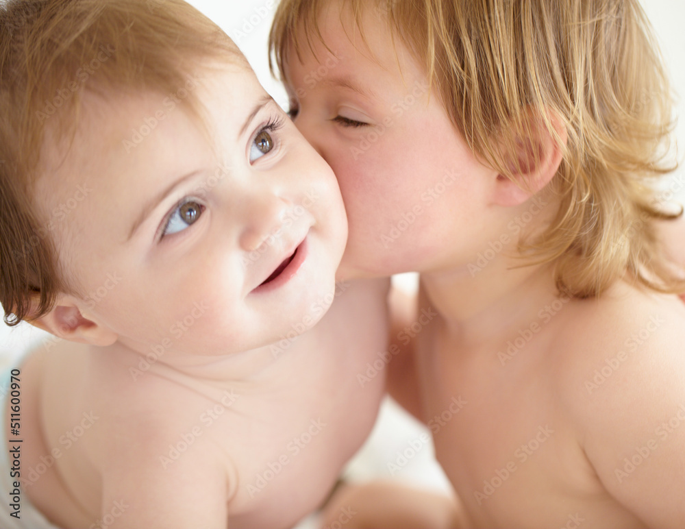 Theres no rivalry between these siblings. Closeup of a sweet little girl giving her baby sister a kiss on the cheek. Theres no rivalry between these siblings. Closeup of a sweet little girl giving her baby sister a kiss on the cheek.