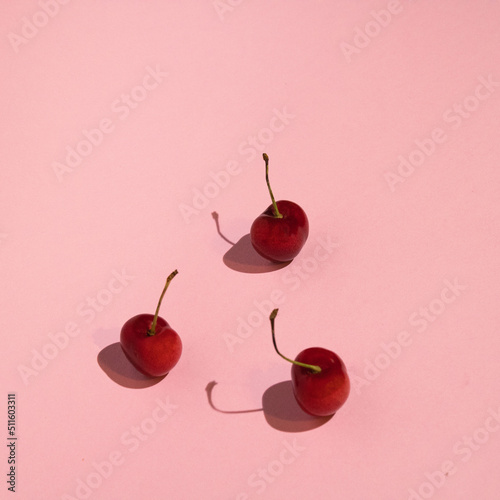 Fresh cherry on pink background. Flat lay concept.