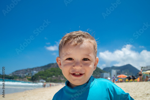 Beautiful little boy on the sand of Copacabana beach, Rio de Janeiro, Brazil photo