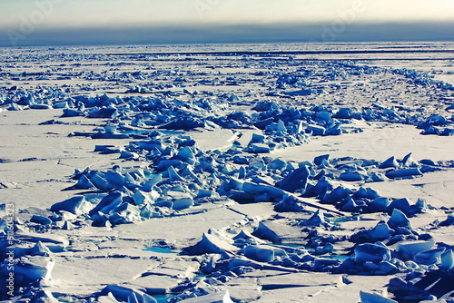 Hummocky field near North pole. Toroses up to ten meters high over ice. Polar ice caps photographed at about 88 degrees north latitude photo