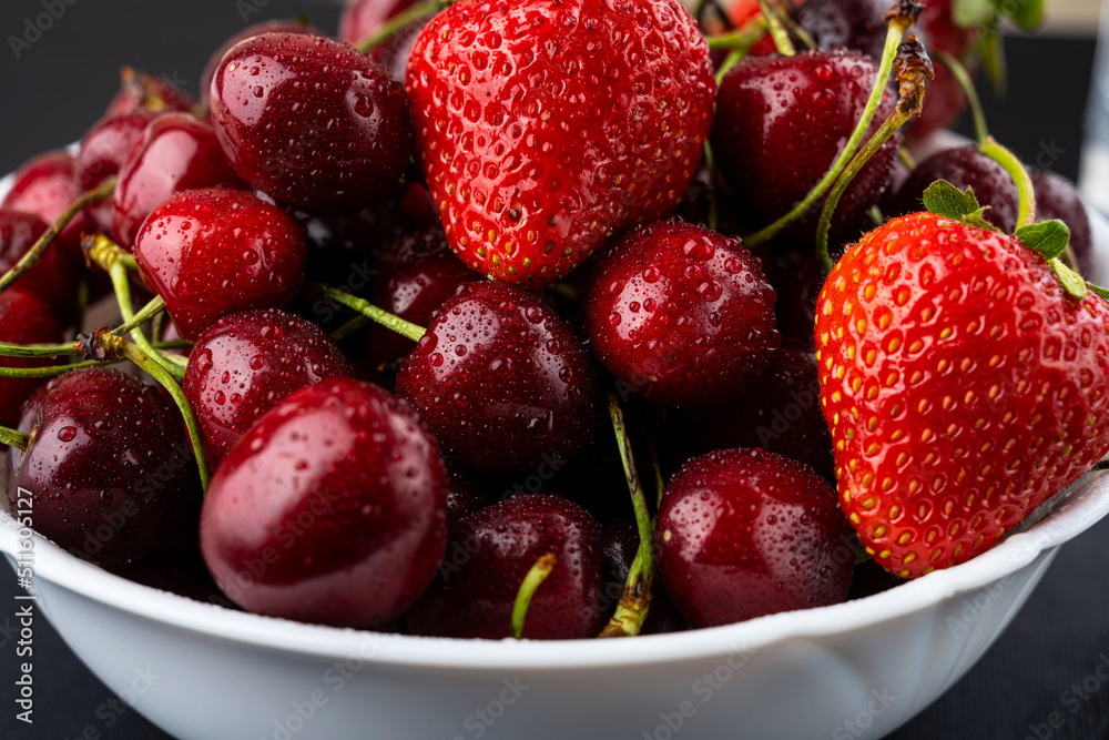 Strawberries and cherries in a bowl. Fresh fruits. juicy berries Strawberries and cherries in a bowl. Fresh fruits. juicy berries