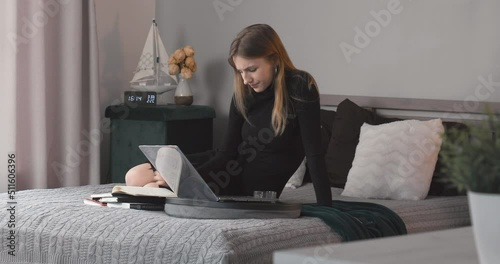 Tired young woman is feeling back pain. Woman working at home