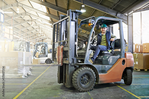 Time to get things moving around here. Portrait of driver in a forklift on the factory floor. © Yuri Arcurs/peopleimages.com