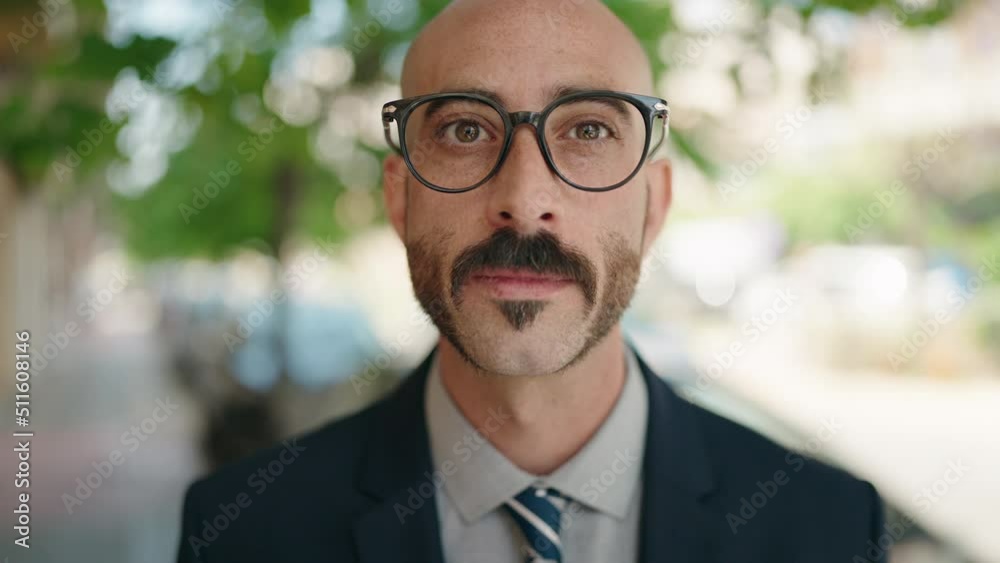 Young hispanic man executive standing with relaxed expression at street Young hispanic man executive standing with relaxed expression at street
