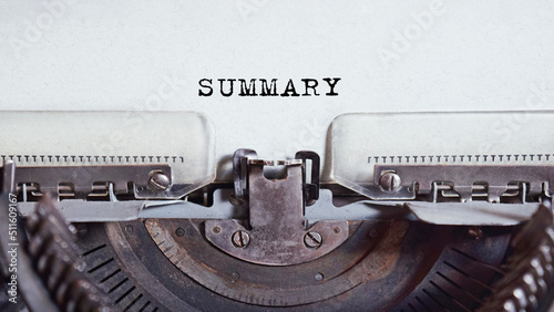 The text is typed on paper by an antique typewriter. Vintage inscription, retro style, grunge, concept. Inscription SUMMARY.