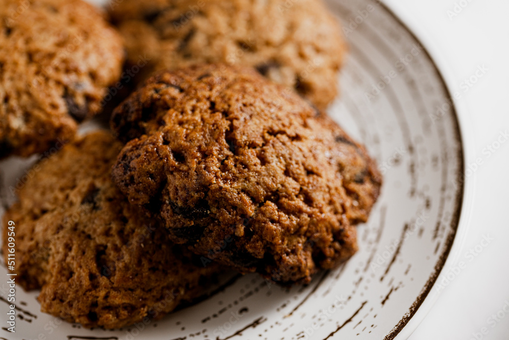 Fototapeta premium macro, close-up photo of handmade cookies on modern designer plate with chocolate chips. copy space