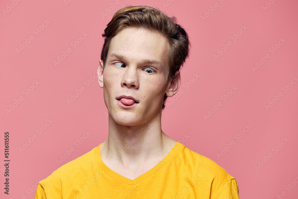funny guy makes faces while standing on a pink background funny guy makes faces while standing on a pink background
