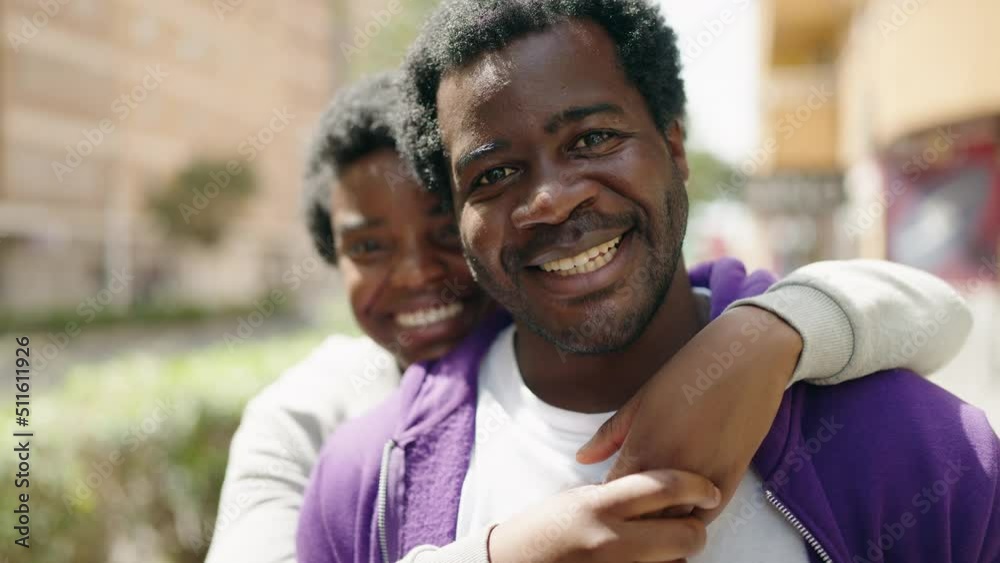 African american man and woman couple smiling confident hugging each other at street African american man and woman couple smiling confident hugging each other at street