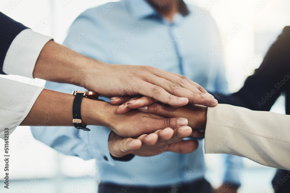 Lets bring it in. Closeup of a group of unrecognizable businesspeople forming a huddle with their hands inside of the office during the day. Lets bring it in. Closeup of a group of unrecognizable businesspeople forming a huddle with their hands inside of the office during the day.