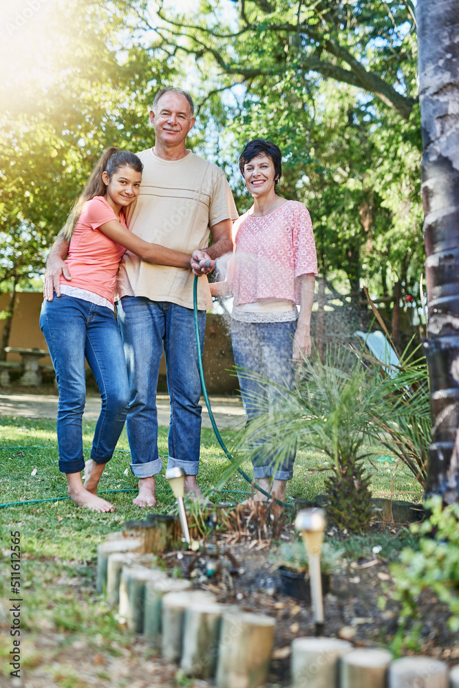 custom made wallpaper toronto digitalOne big happy family. Portrait of a family watering a garden with a hose.
