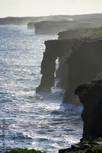 Holei Sea Arch, a lava rock column on the side of a cliff along the Chain of Craters Road in the Hawaiian Volcanoes National Park on the Big Island of Hawai'i in the Pacific Ocean photo