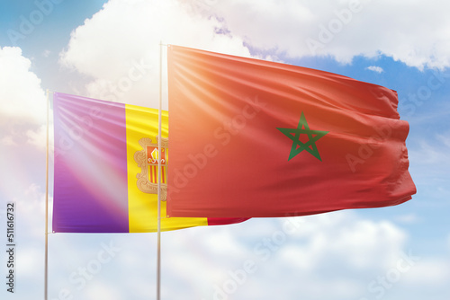 Sunny blue sky and flags of morocco and andorra
