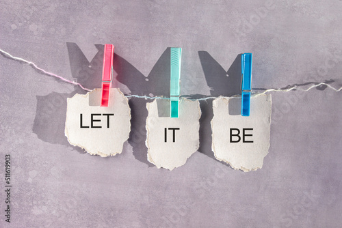 Paper sheets on a rope secured with clothespins with text Let it be