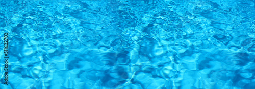 Texture of blue water in swimming pool as background. Banner design