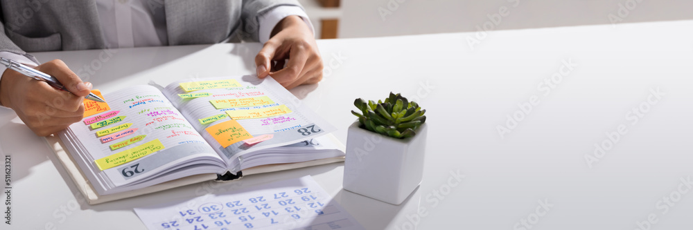 Obraz premium Businesswoman Making Agenda On Personal Organizer
