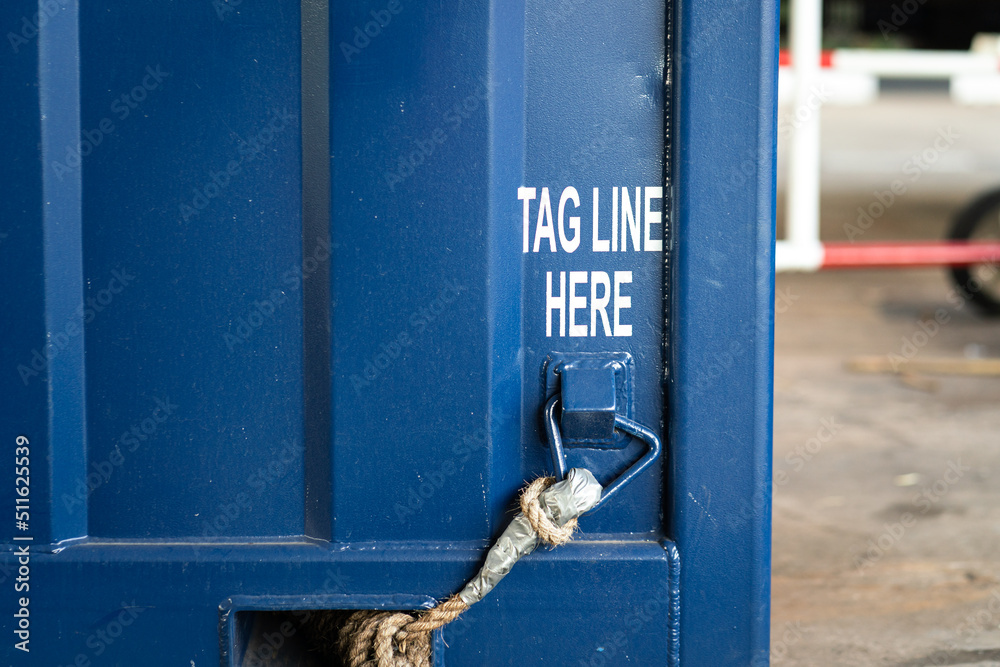 Tagline point on the heavy container box, hook up with long rope which is used to control the object when lifting without hand on load. Industrial equipment and object photo. - obrazy, fototapety, plakaty 